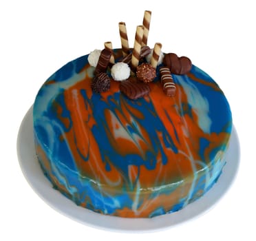 Mirror glaze cake with swirls of blue, red and white