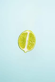 slice of lime isolated on blue background