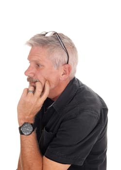 A gray hared middle aged man sitting isolated for white background with.his hand on chin and glasses on his head, isolated for white background.