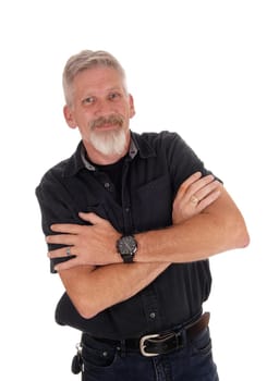 A portrait image of a forties year old man dressed in black with his arms.crossed and nice gray beard, isolated for white background.