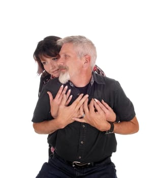 A happy middle age couple hugging each other, the wife behind.her husband, isolated for white background.