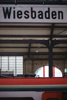 Wiesbaden,Germany - October 15,2017: The sign Wiesbaden Hauptbahnhof below the roof structure of the building on October 15,2017 in Wiesbaden.
