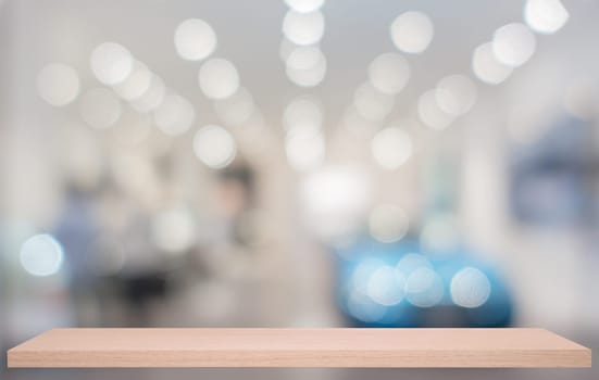 defocused image of Commercial car stand in show room with wooden shelf
