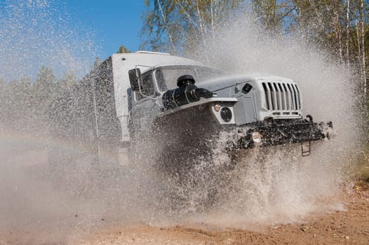 the truck passes through a puddle