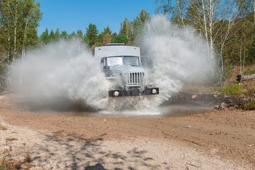 the truck passes through a puddle