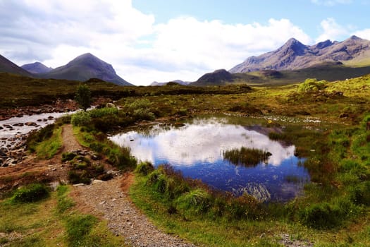 Landscape with river,moor lake and mountains in the Scottish Highlands on the Isle of Skye