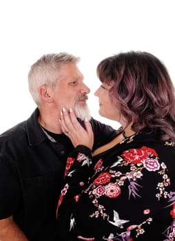 A middle age couple in a loving gesture in a closeup image, isolated for.white background.