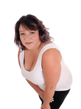 A pretty middle age woman in a white t-shirt standing isolated for.white background bending forwards.