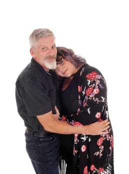 A lovely couple standing from the front and hugging, the wife with her.head on his chest, isolated for white background.