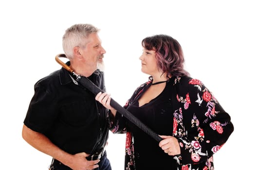 A middle age couple in a close-up image having an argument and the.wife put a umbrella around man's neck, isolated for white background.