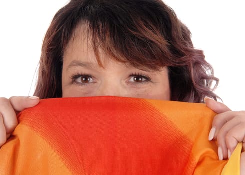 A brunette woman holding a colorful scarf over her mouths, looking.into the camera, isolated for white background.