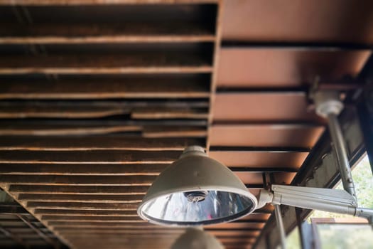 Industrial light lamp with grunge rusty ceiling, stock photo