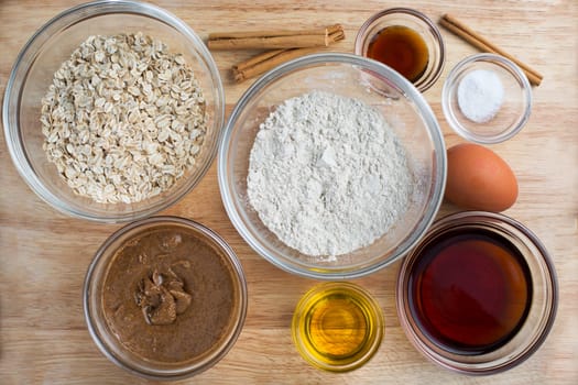 Ingredients for baking healthy oatmeal cookies including maple syrup.