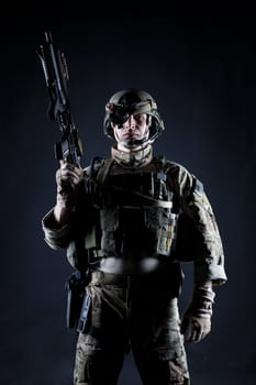 United States Army ranger with assault rifle on dark background