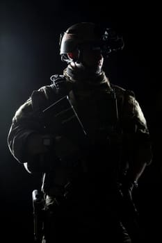 United States Army ranger with assault rifle on dark background