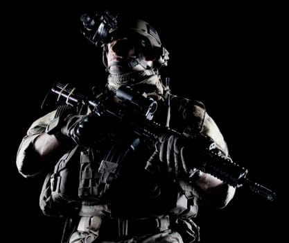 United States Army ranger with assault rifle on dark background