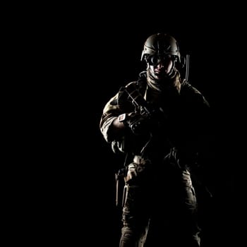 United States Army ranger with assault rifle on dark background