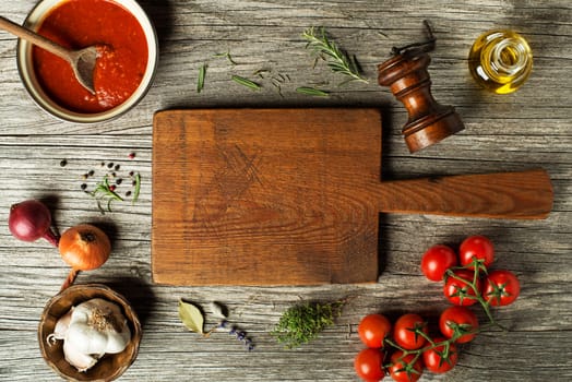 Fresh ingredients for cooking tomato sauce or soup on wooden background place for text. Vegan food vegetarian and healthy cooking concept.