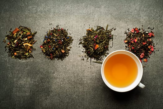 Cup of tea with dry tea collection of different types