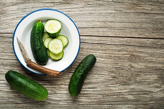 Fresh green cucumber sliced prepare for meal on wooden background
