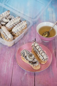 Cakes with tea on gradient color background