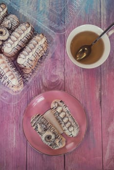 Cakes with tea on gradient color background