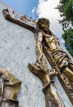 Jesus frees himself from the cross and shakes his hand to a faithful. Shallow depth of field.