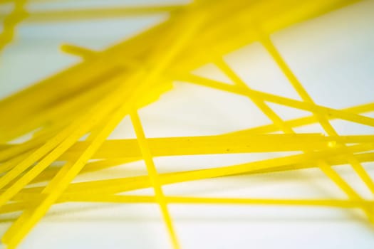 raw spaghetti pasta on a white background. Macro shot