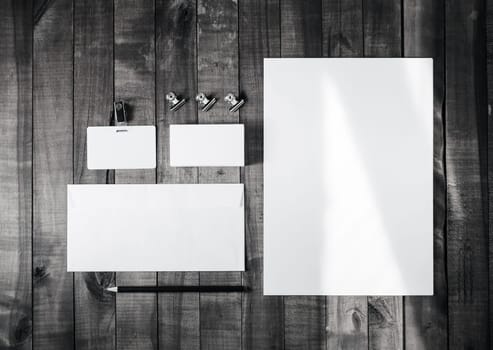 Blank corporate stationery on wood background. Branding mockup for placing your design. Top view.