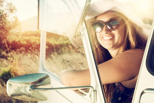 Girl posing in a car in sunset during vacations