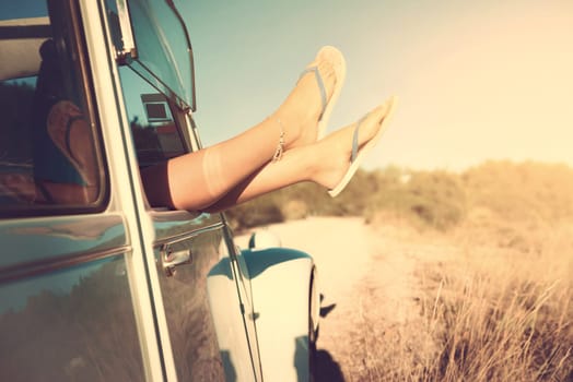 girl's legs in a retro car at sunset, retro style.