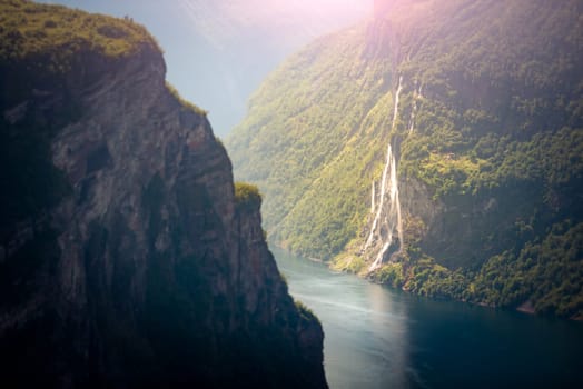 Waterfall in fiord, Norway, Scandinavia, Europe. High mountains over fjord.