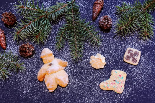 A Santa Claus and cookies made of dough. Christmas decoration on blue glass