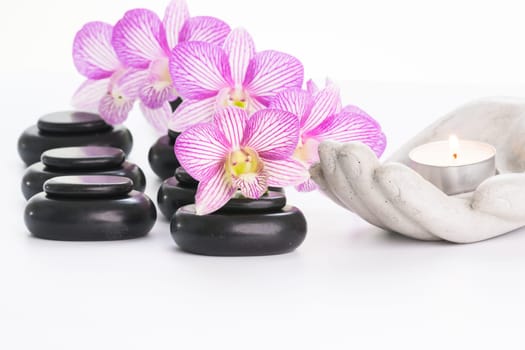 Spa concept with hot stones and candle