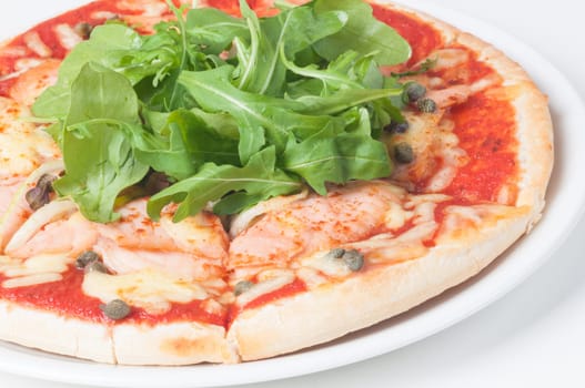 Salmon pizza with fresh Arugula salad and capers