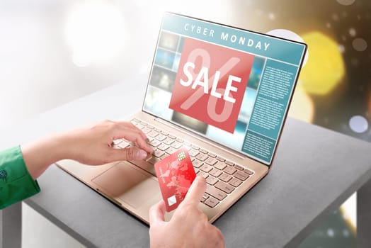 Hands with laptop holding credit card for online shopping payment. Cyber Monday concept