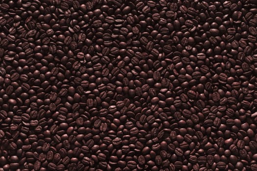 Roasted coffee beans on a flat background.