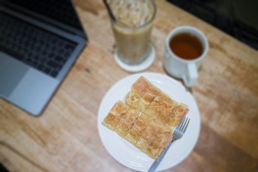Easy meal in work hour with coffee drink and fried roti, stock photo