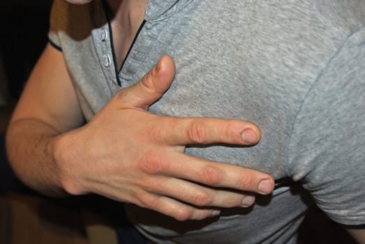 Young man having a heart attack