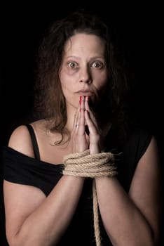 Abused woman victim of domestic violence tied with rope