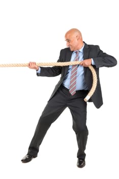 Businessman pulling a rope isolated in white