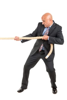 Businessman pulling a rope isolated in white