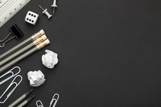 Office accessories on black paper background. Minimal style. Copy space. Top view