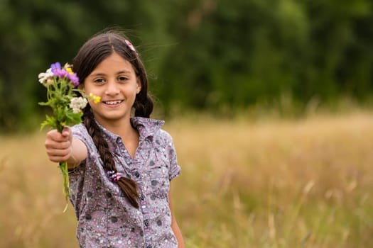 Pretty girl with self-picked bouquet of flowers