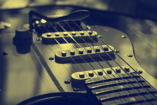Vintage guitar stratakaster system close up. Yellow blue toning.