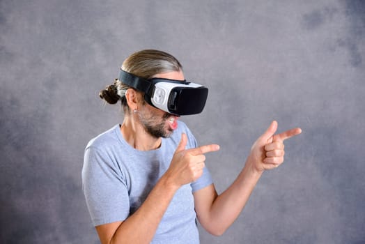 young man with virtual reality glasses playing shooting game