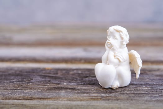 sill life with angel on wooden ground