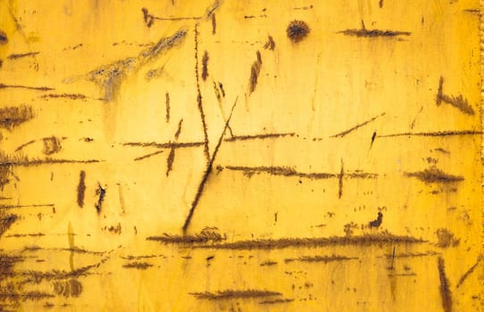 Metallic texture of cracked yellow paint