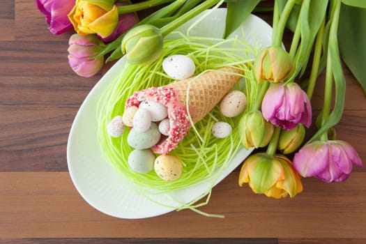 Easter eggs in waffle toe on Easter nest made of dish paper