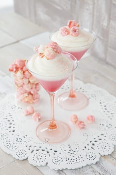 Cream dessert with popcorn in a martini glass